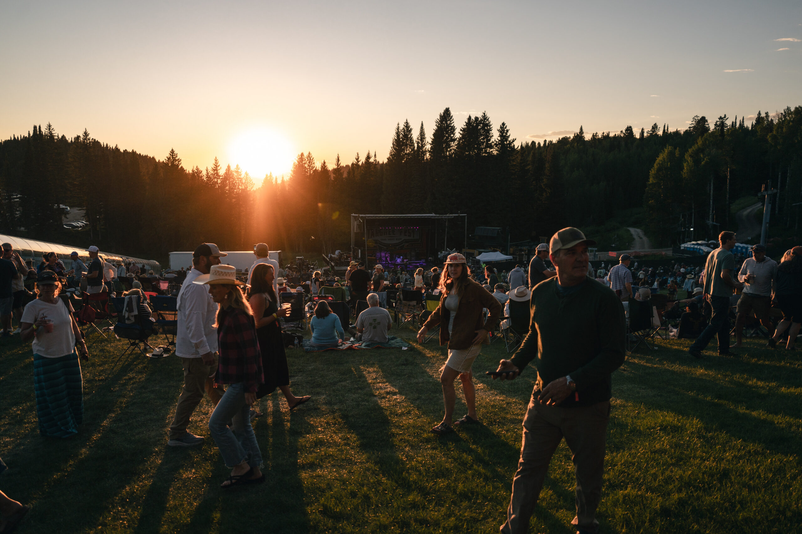 Crowd at sunset in front of a stage at Grand Targhee Music Festival
